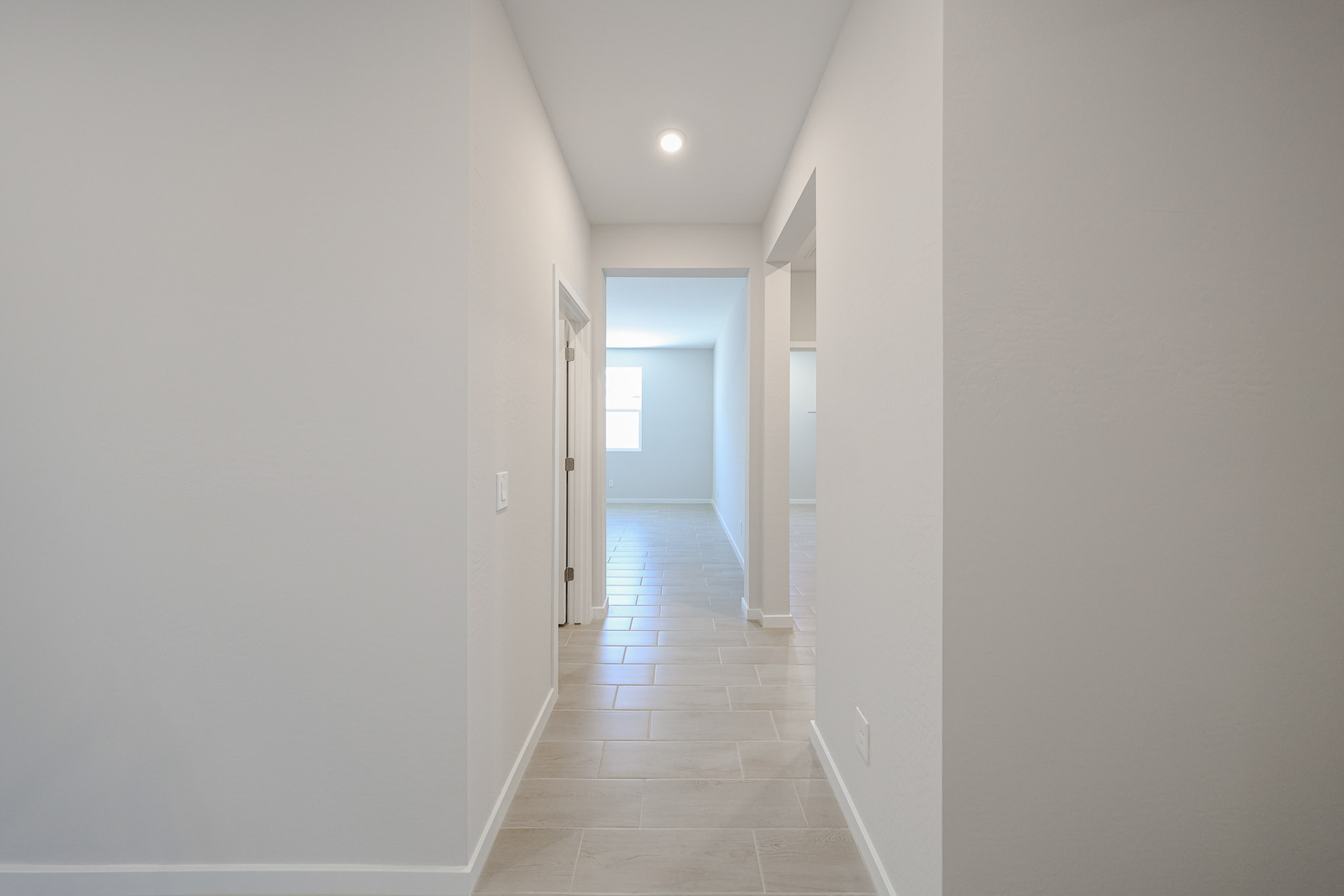 A hallway with white walls.