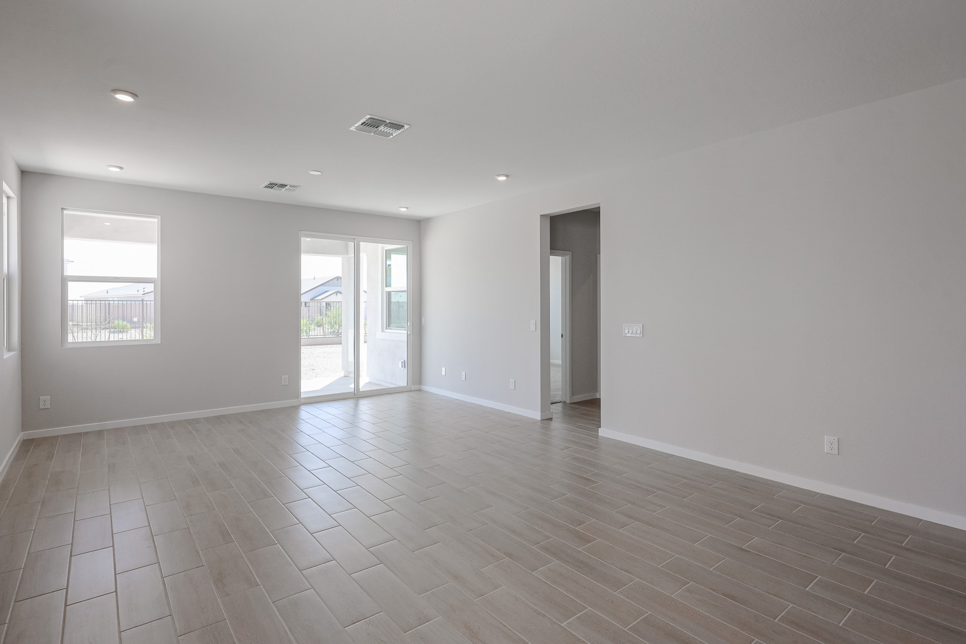 A room with a wood floor and white walls.