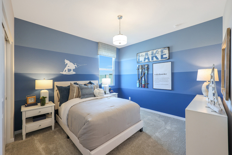 A bedroom with a bed and lamps.