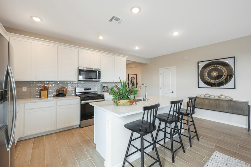 A kitchen with white cabinets.