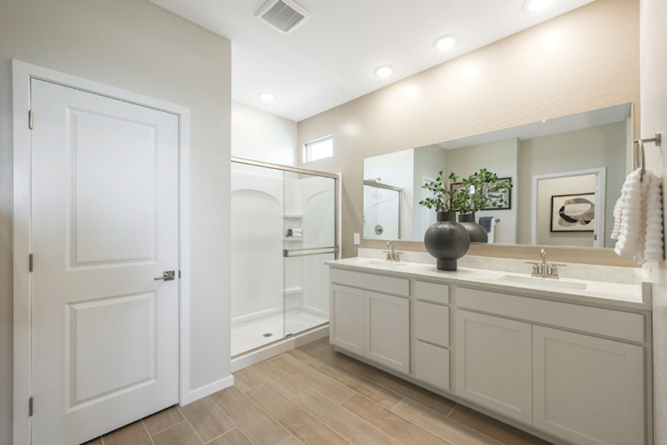A bathroom with white cabinets.