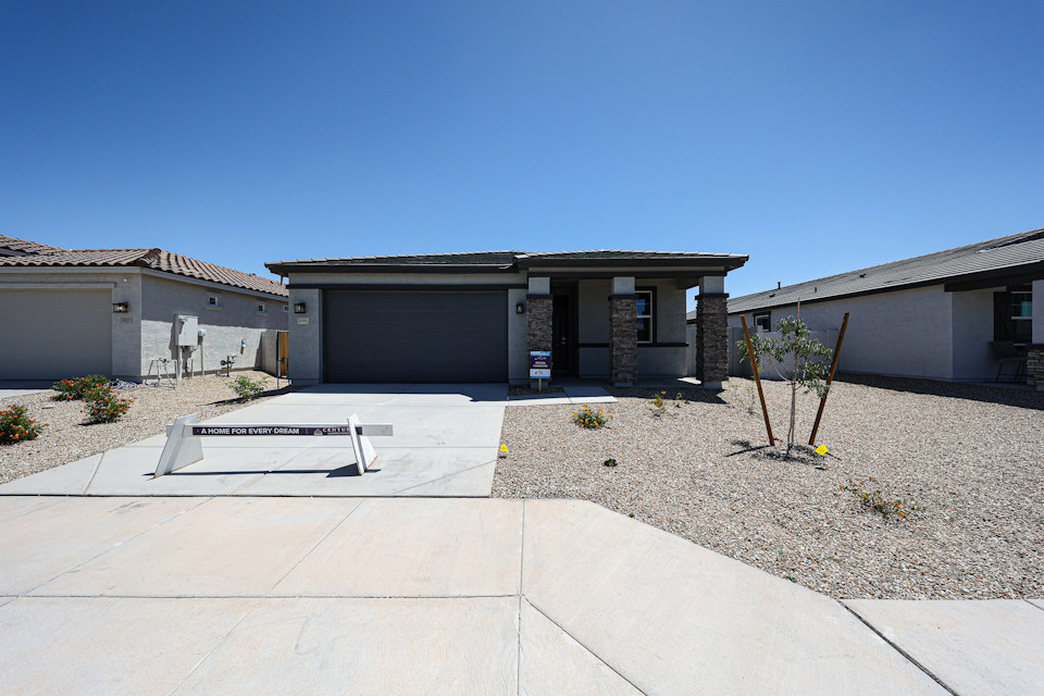 A building with a bench in front.