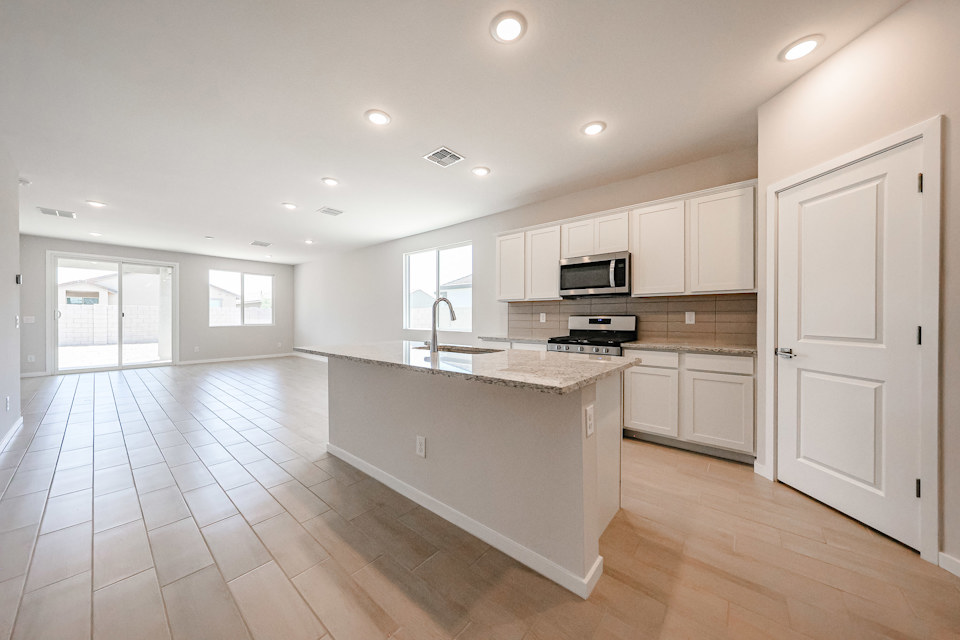 A kitchen with white cabinets.