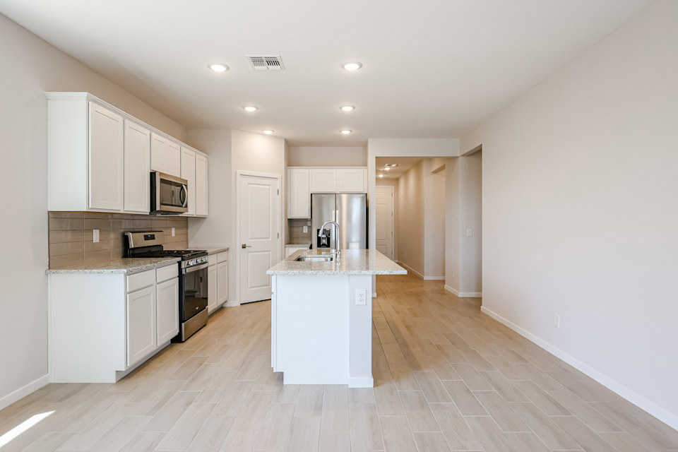 A kitchen with white cabinets.