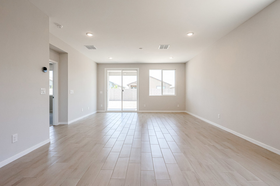 A room with a wood floor and white walls.