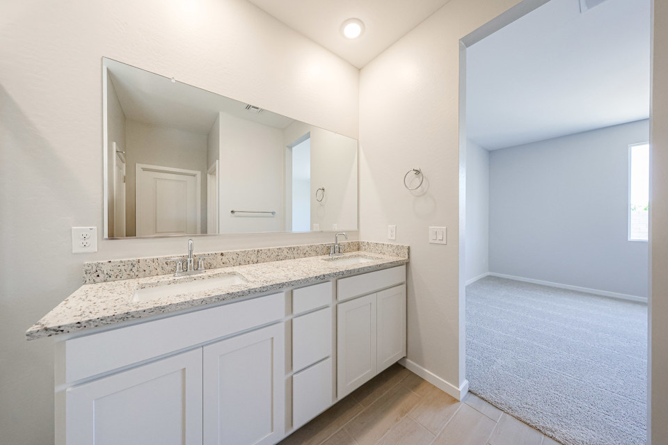 A bathroom with a large mirror.