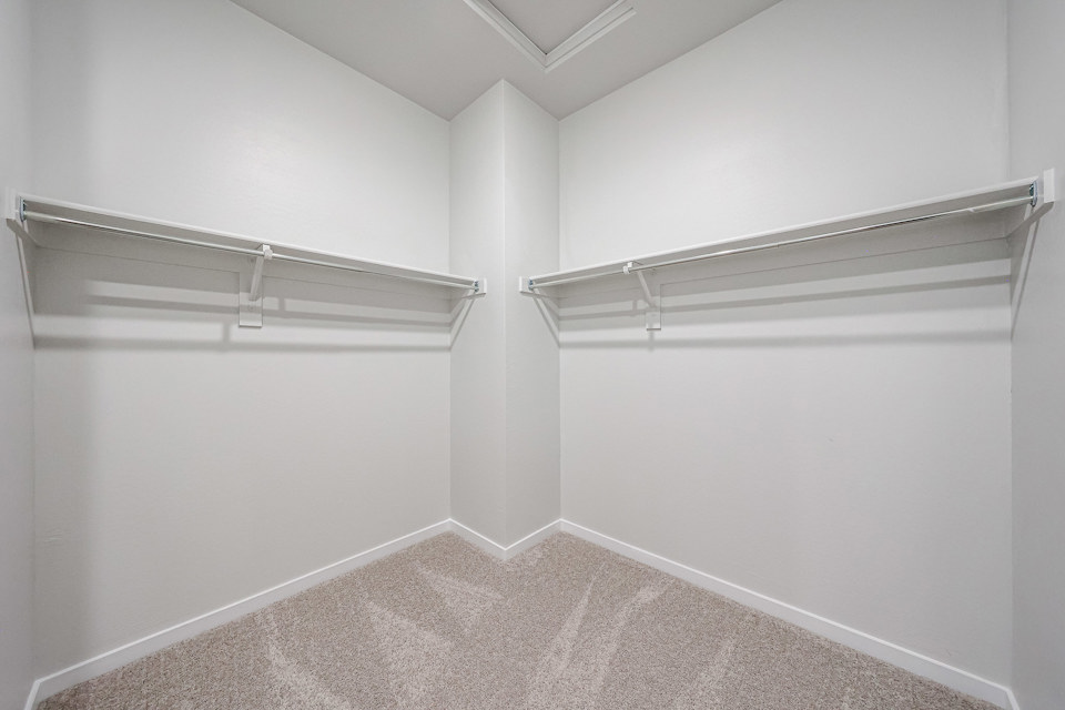 A white wall with a metal railing.