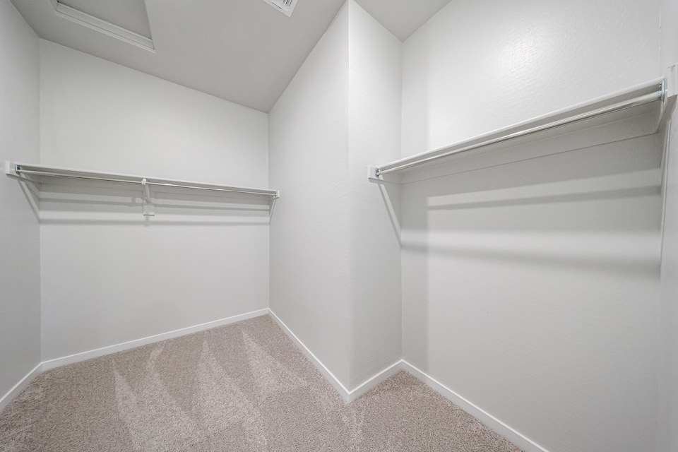 A white wall with a metal railing.