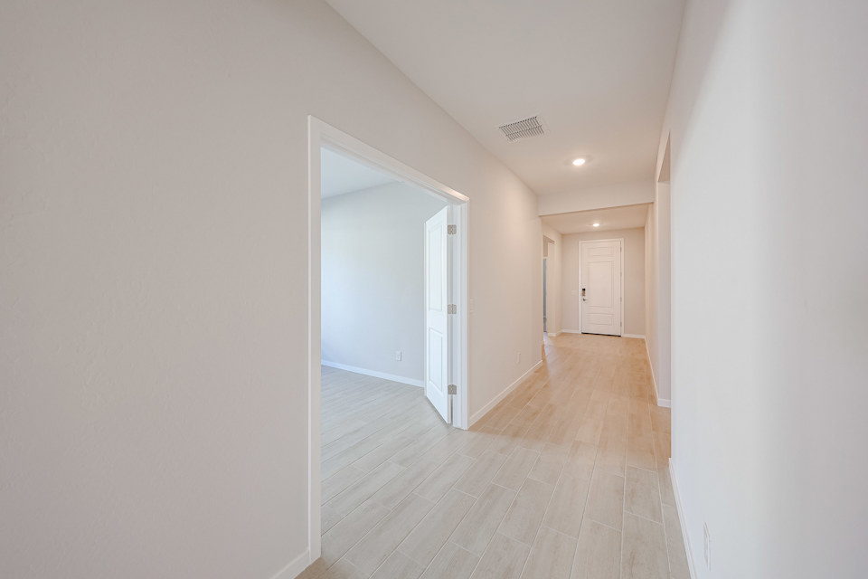A hallway with white walls.