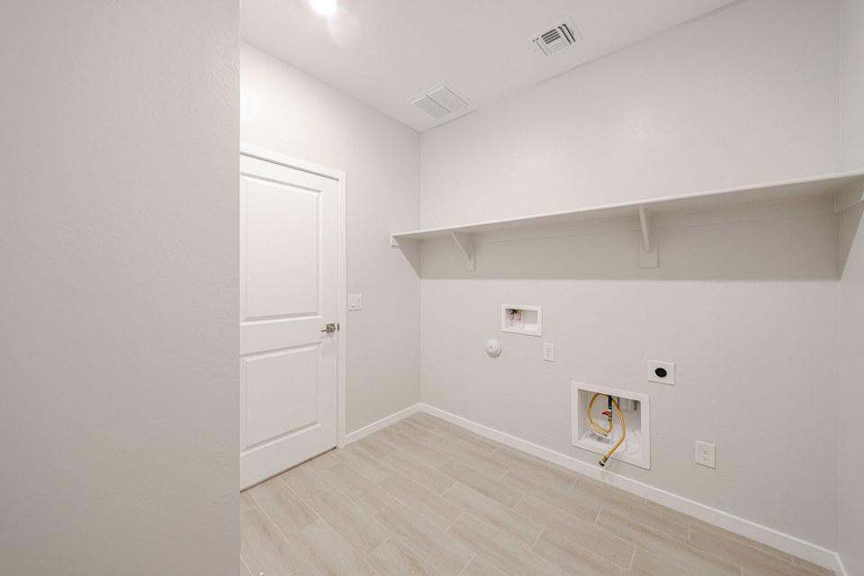 A room with a wood floor and white walls.