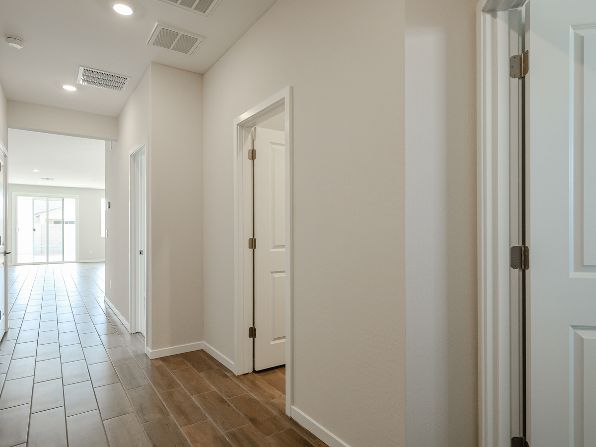 A hallway with white doors.