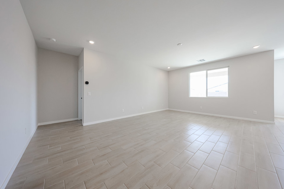 A room with a wood floor and white walls.