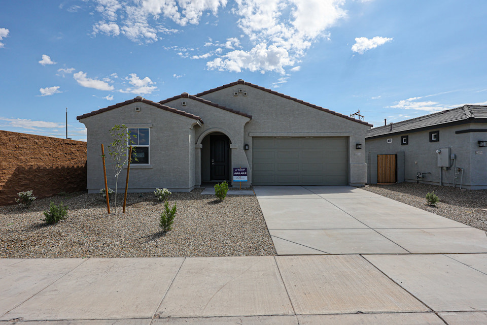 A building with garages and a sidewalk.