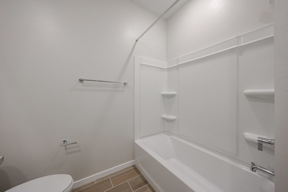 A bathroom with a bathtub toilet and shower.