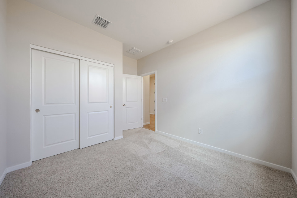 A hallway with white doors.