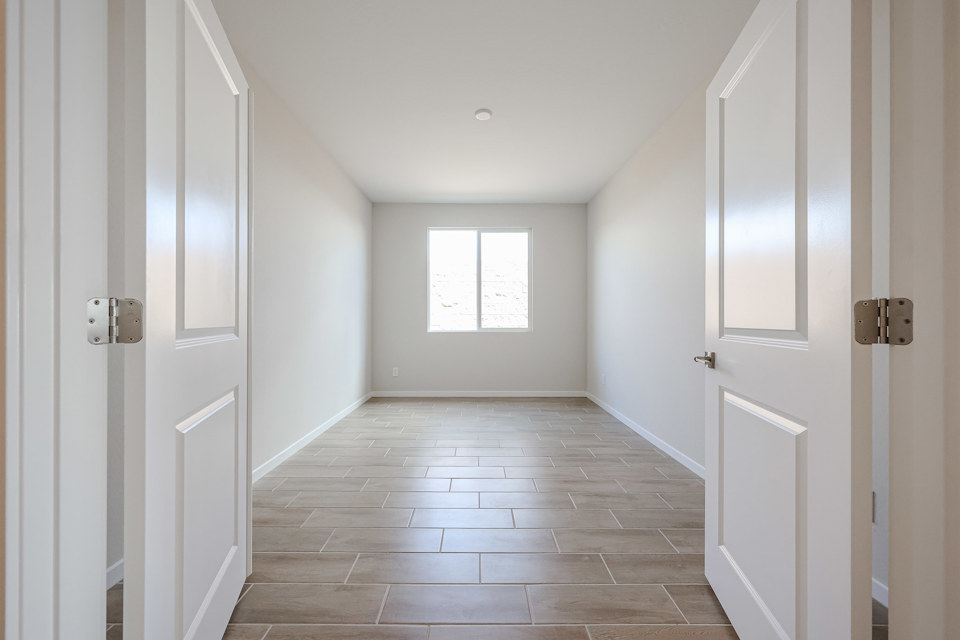 A hallway with white doors.