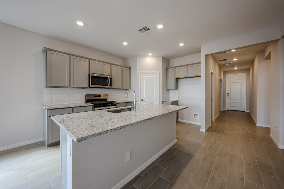 A kitchen with white cabinets.
