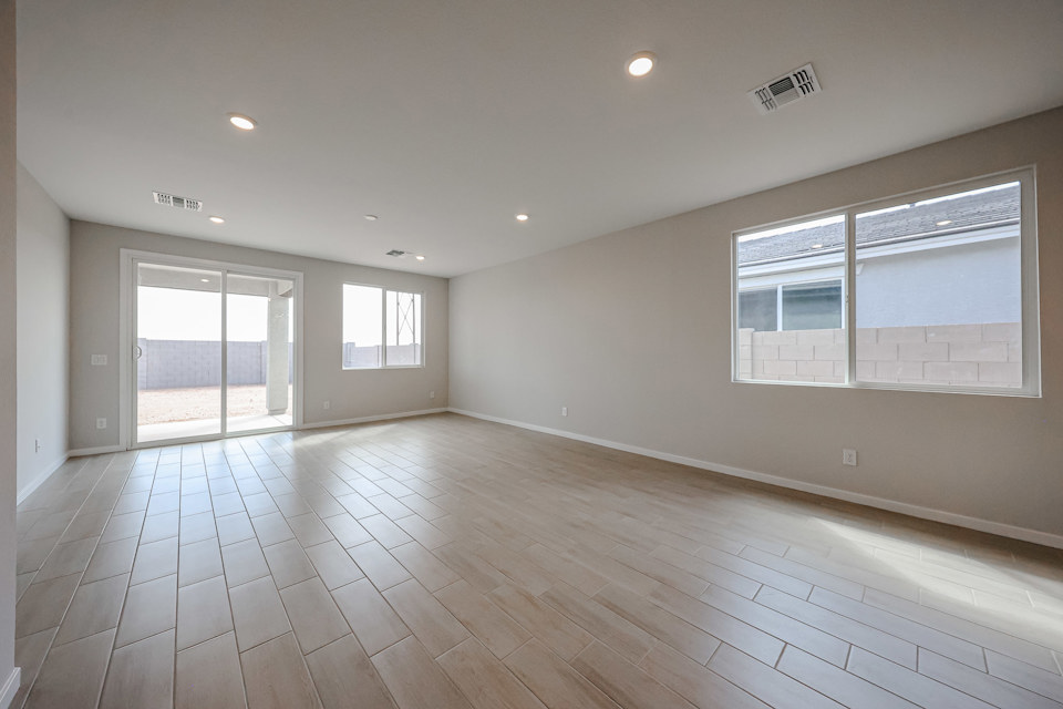 A room with windows and wood floors.