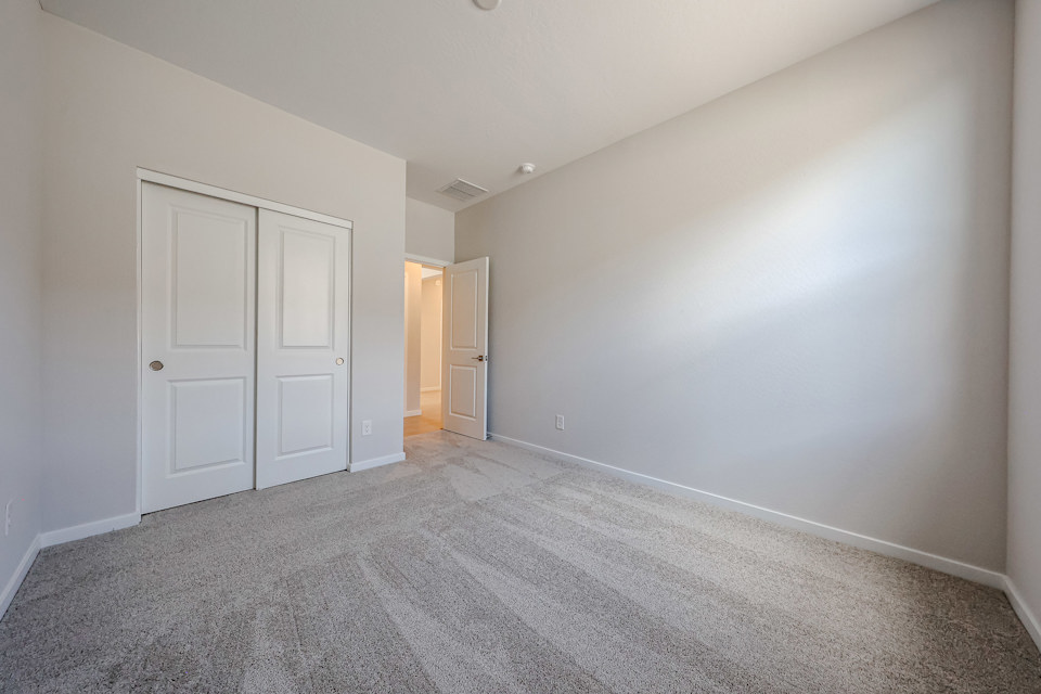 A hallway with white doors.