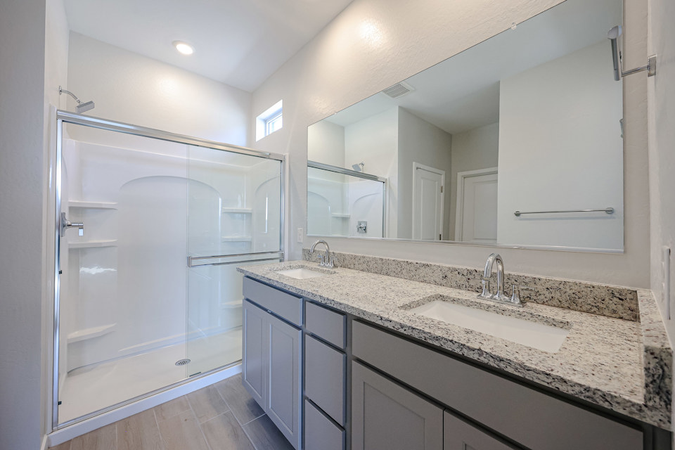 A bathroom with a large mirror.