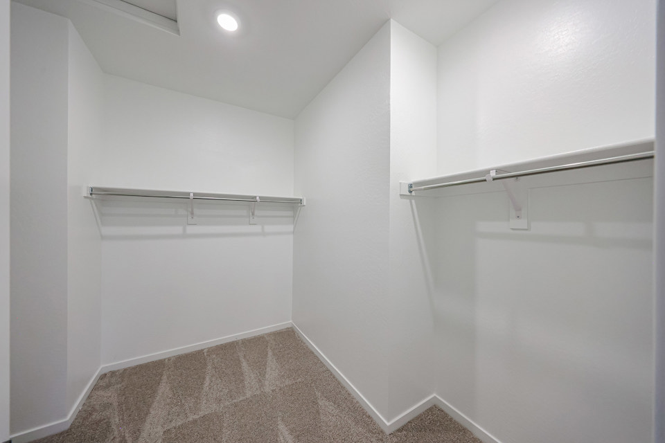 A white room with a metal bar.