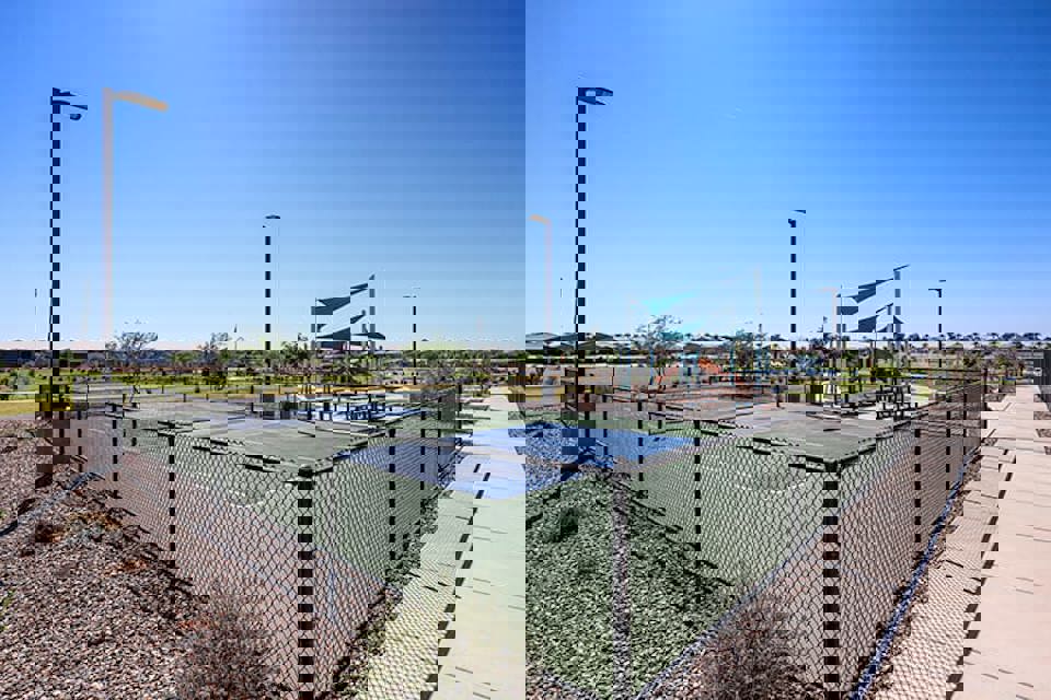 A fenced off area with a metal gate and a walkway.