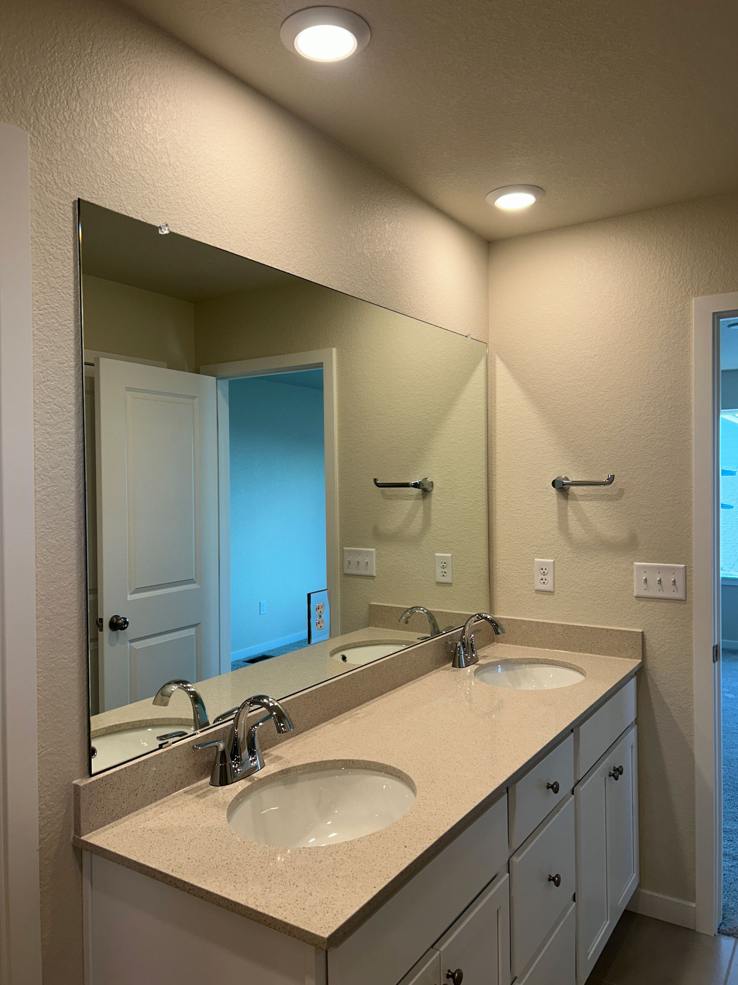 A bathroom with a large mirror.