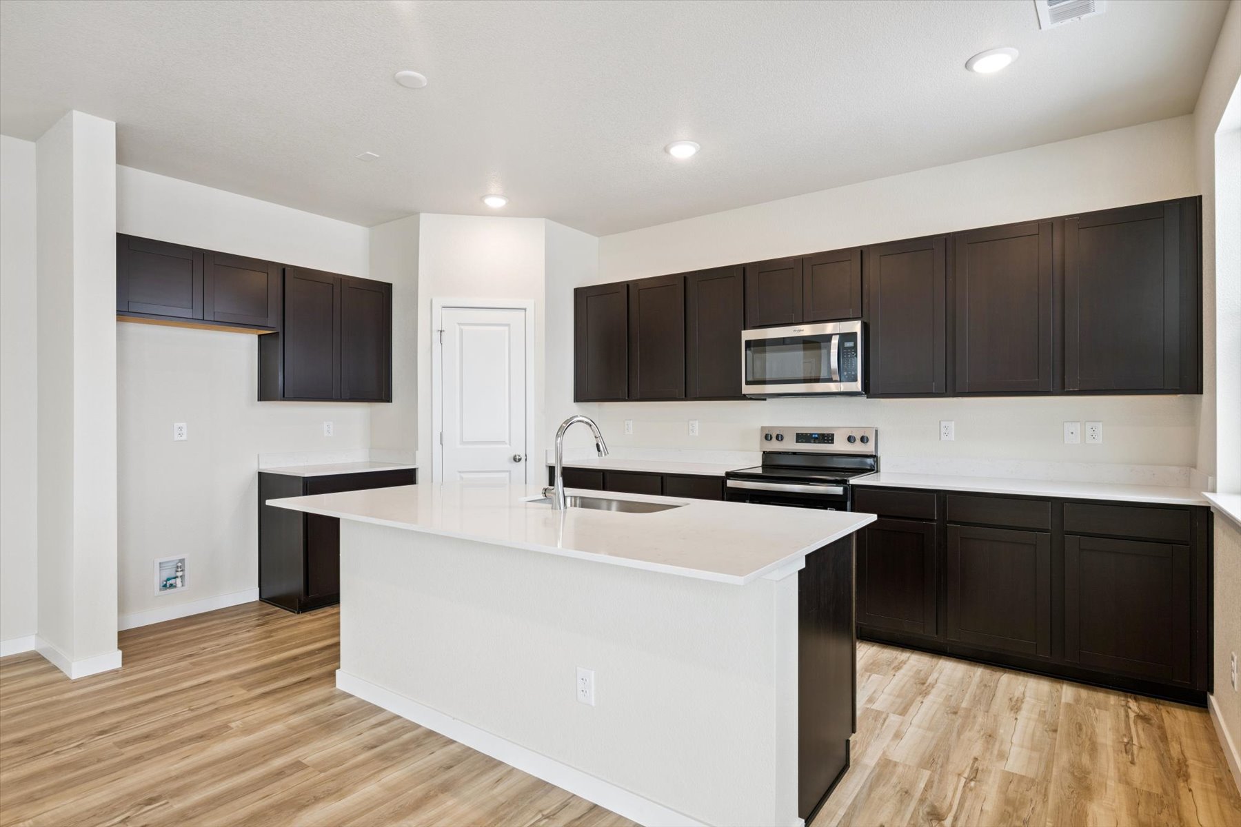 A kitchen with black cabinets.
