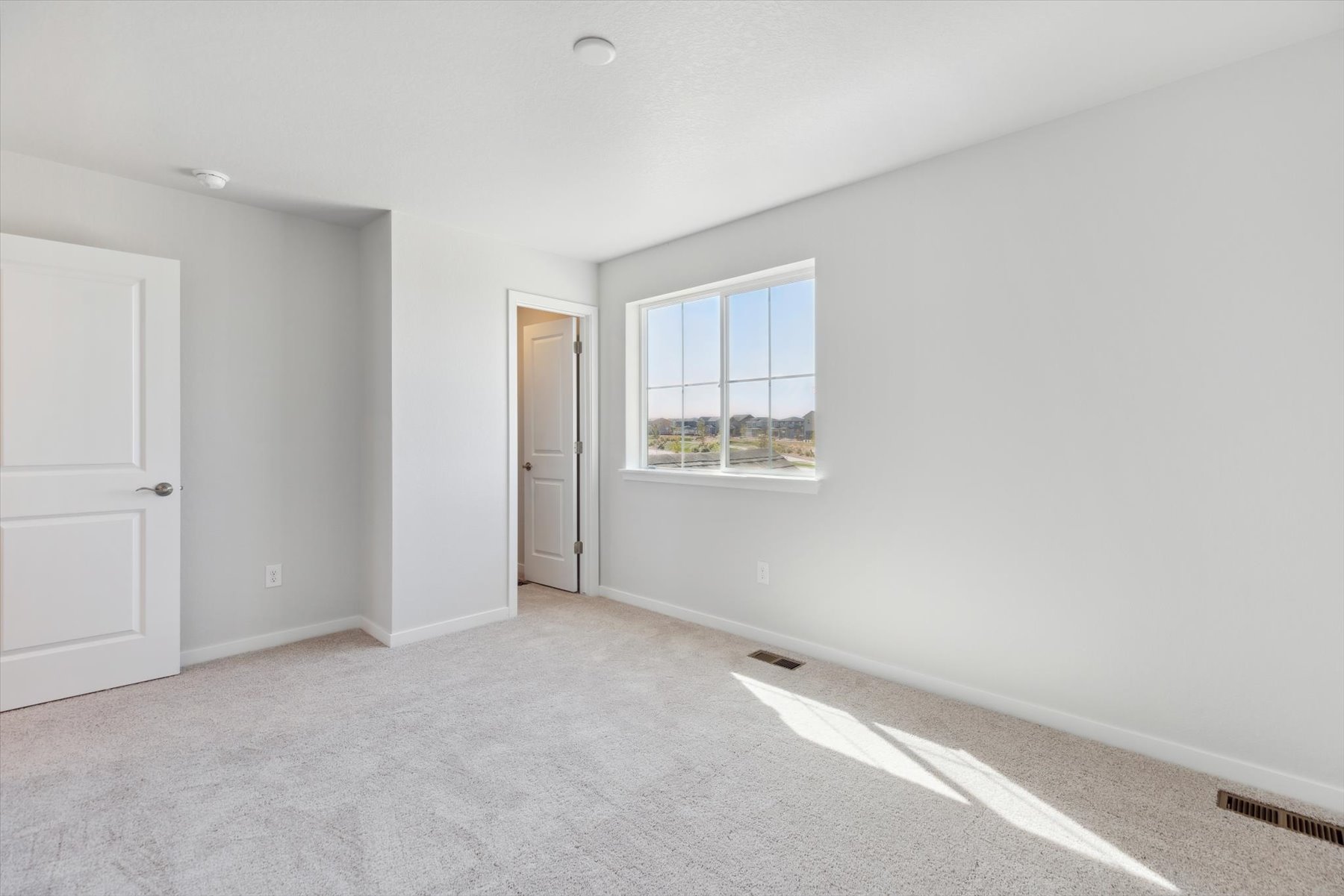 A room with a window and a door.