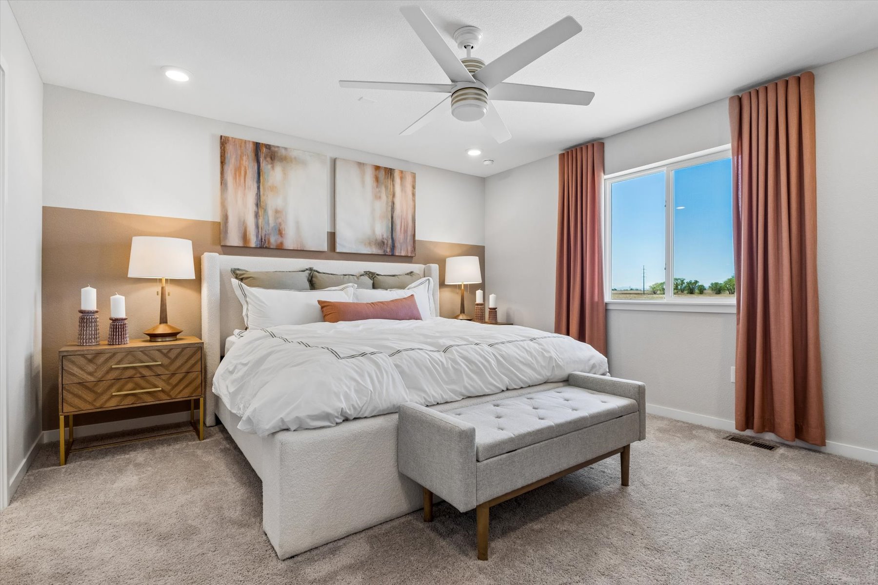 A bedroom with a bed and a bench.