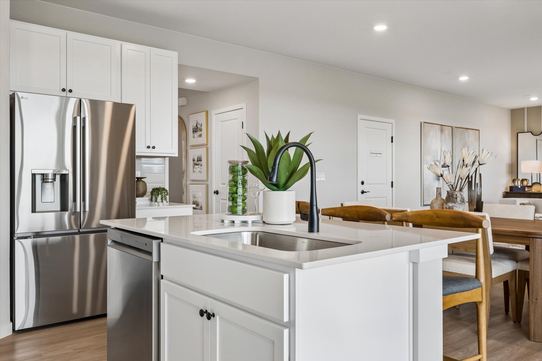 A kitchen with white cabinets.