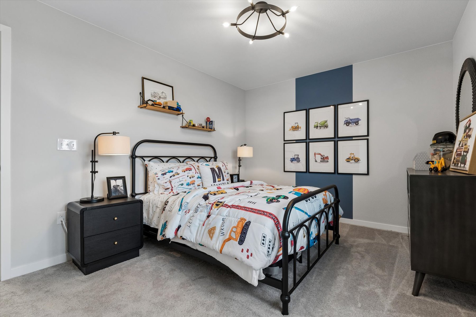 A bedroom with a bed and dresser.