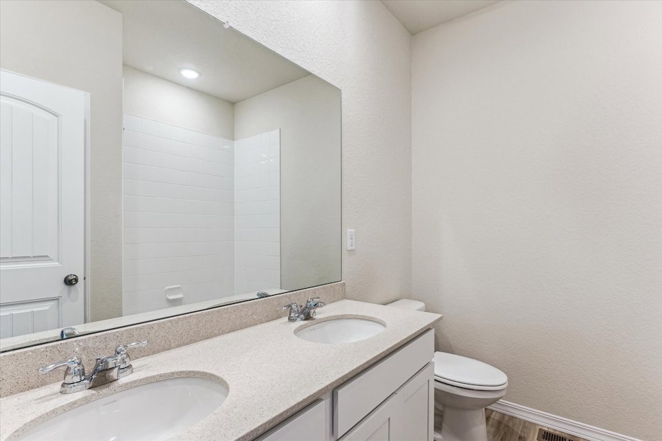 A bathroom with a large mirror.
