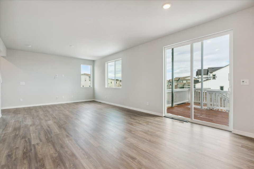 A room with a wood floor and a wood floor with a glass door.
