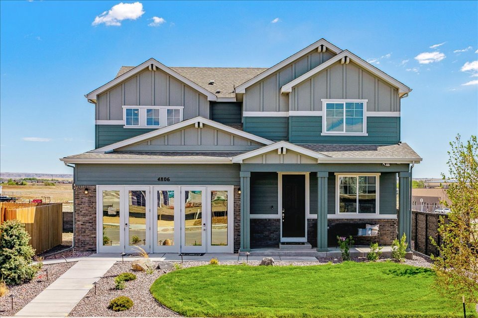 A house with a green lawn.