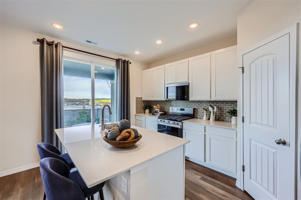 A kitchen with white cabinets.