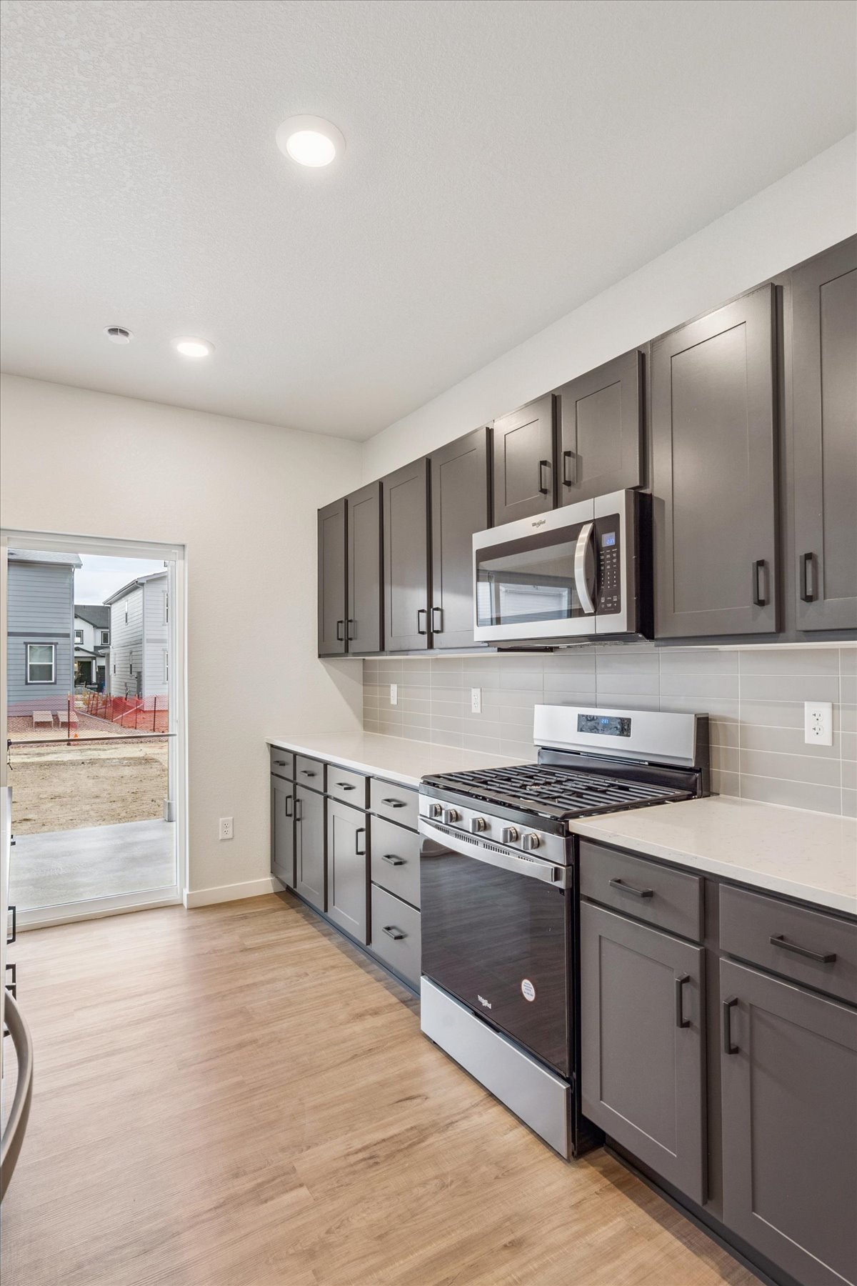 A kitchen with black cabinets.