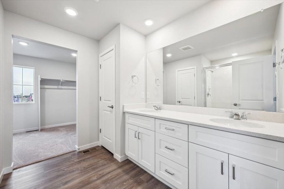 A bathroom with white cabinets.