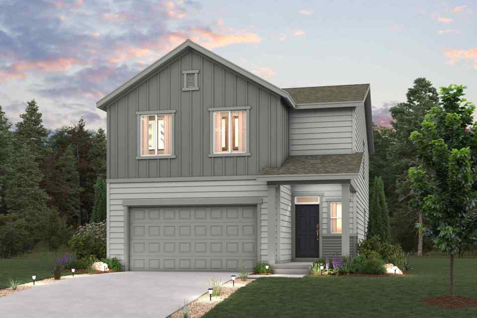 A house with a garage and trees in the back.