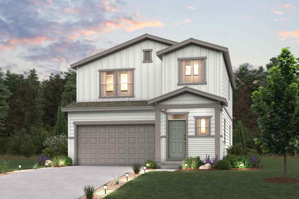 A house with a garage and trees.