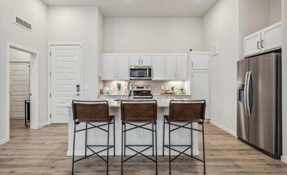 A kitchen with a table and chairs.