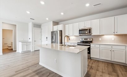A kitchen with white cabinets.