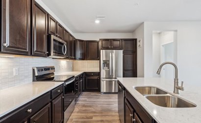A kitchen with black cabinets.