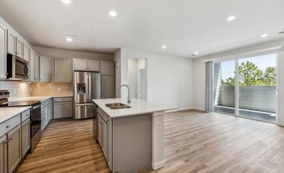 A kitchen with wooden floors.