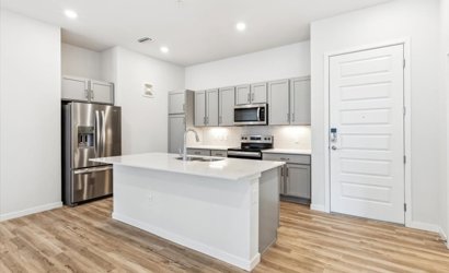 A kitchen with white cabinets.