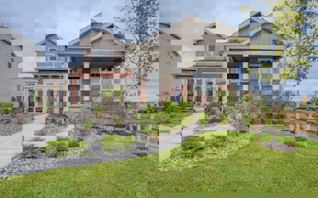 A house with a yard and a fence.