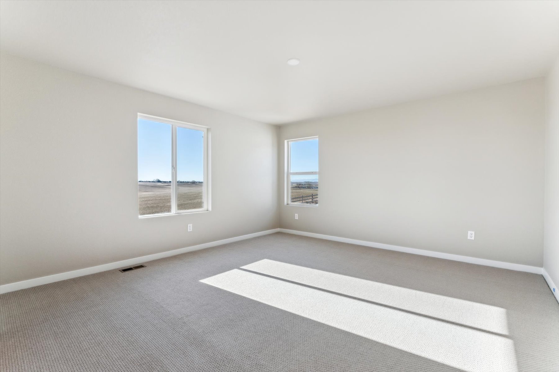 A room with a white floor and windows.