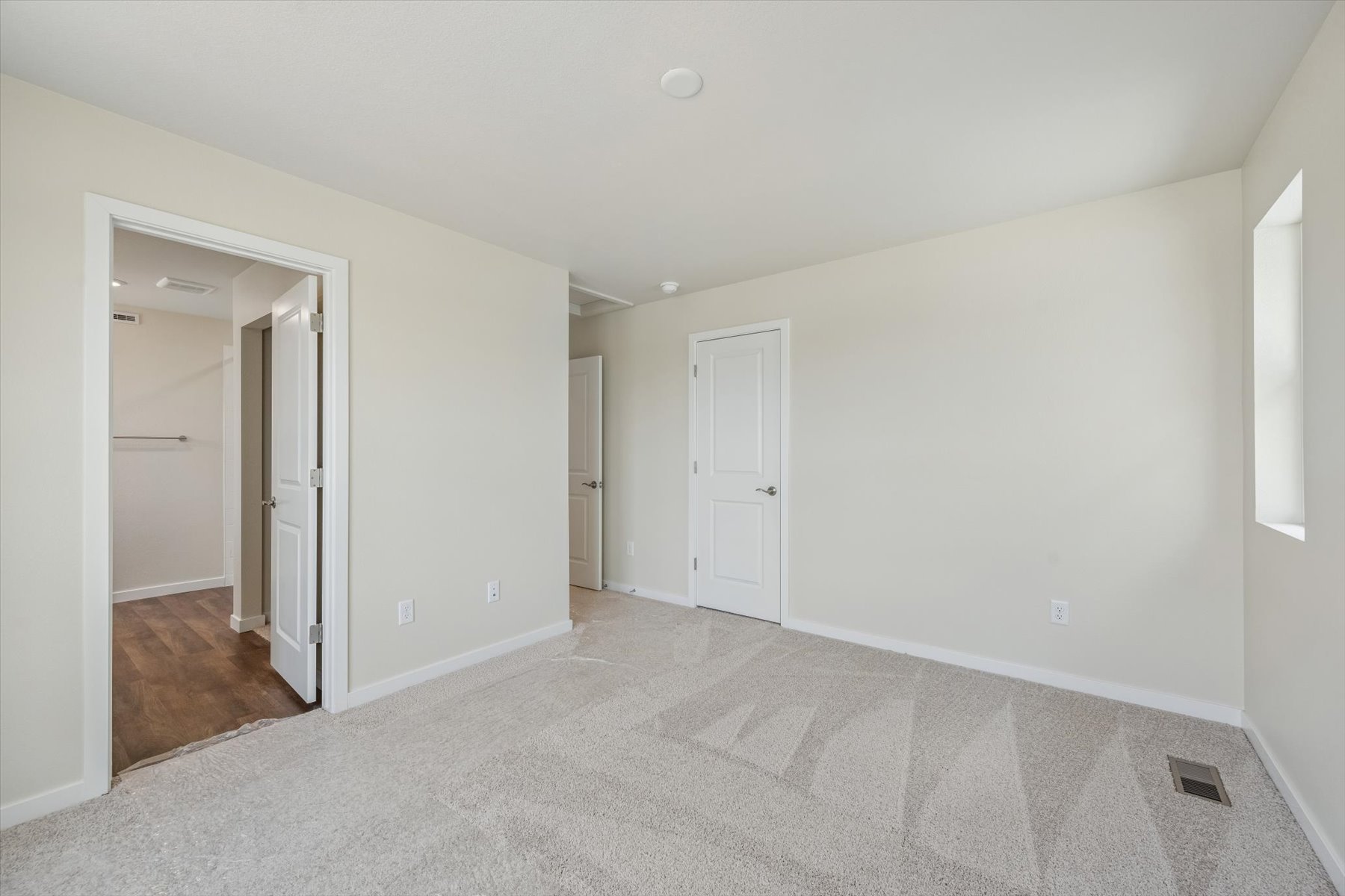 A hallway with white doors.