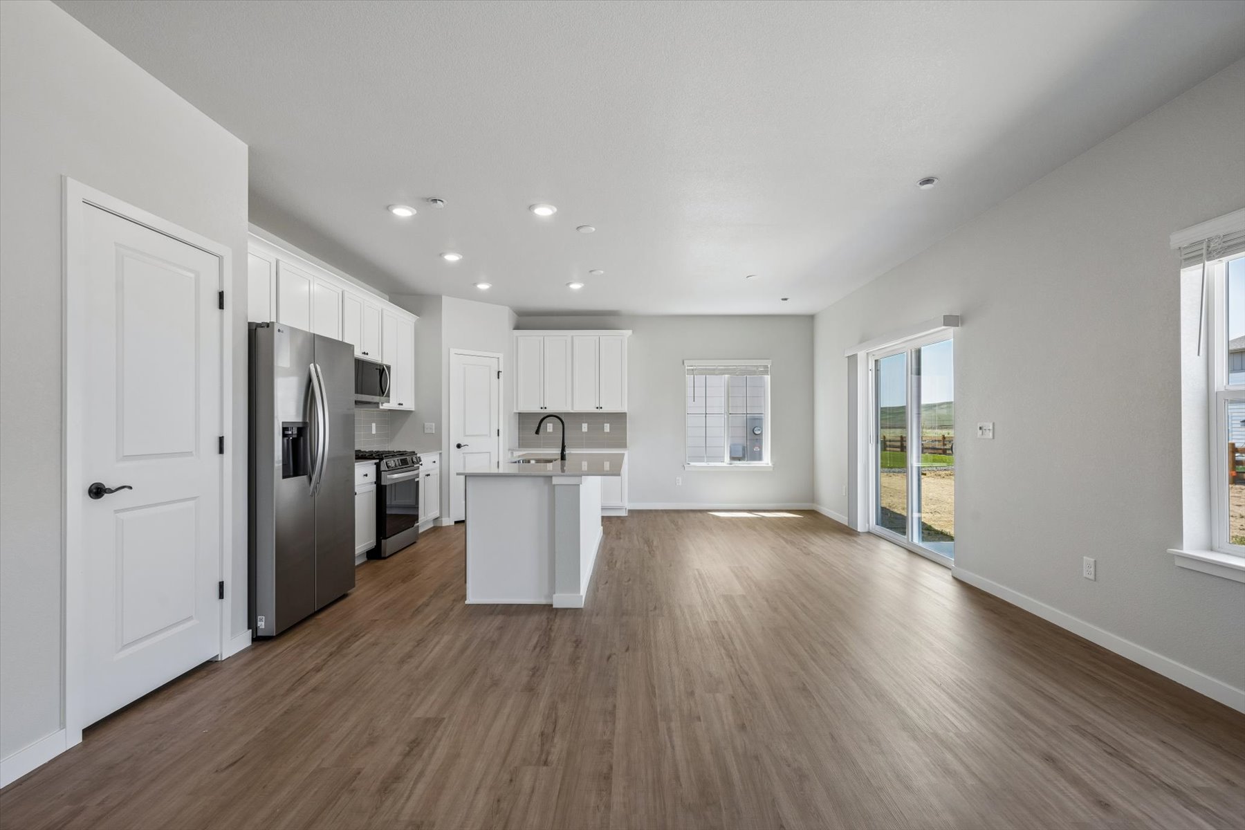 A kitchen with white cabinets.