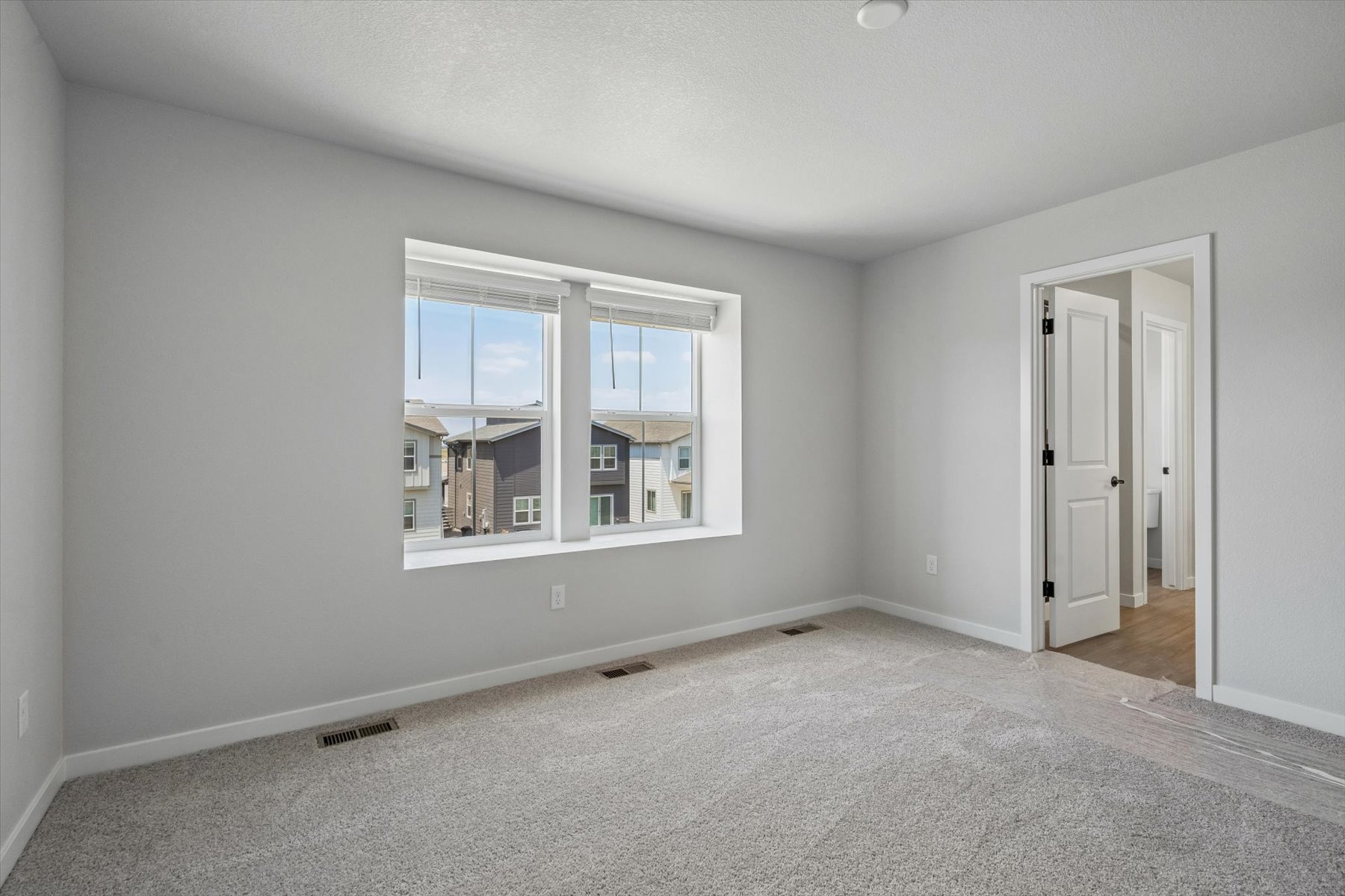 A room with a window and a door.